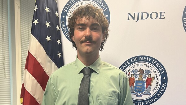 Cape May County Technical Schools senior Alec Dooley holding his recognition plaque after being honored at the NJ state Board of Education Student Recognition Ceremony.
